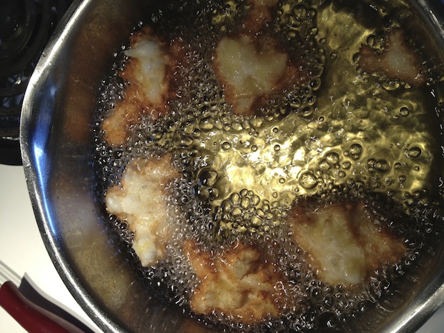 cooking apple fritters (portselkje) in hot oil